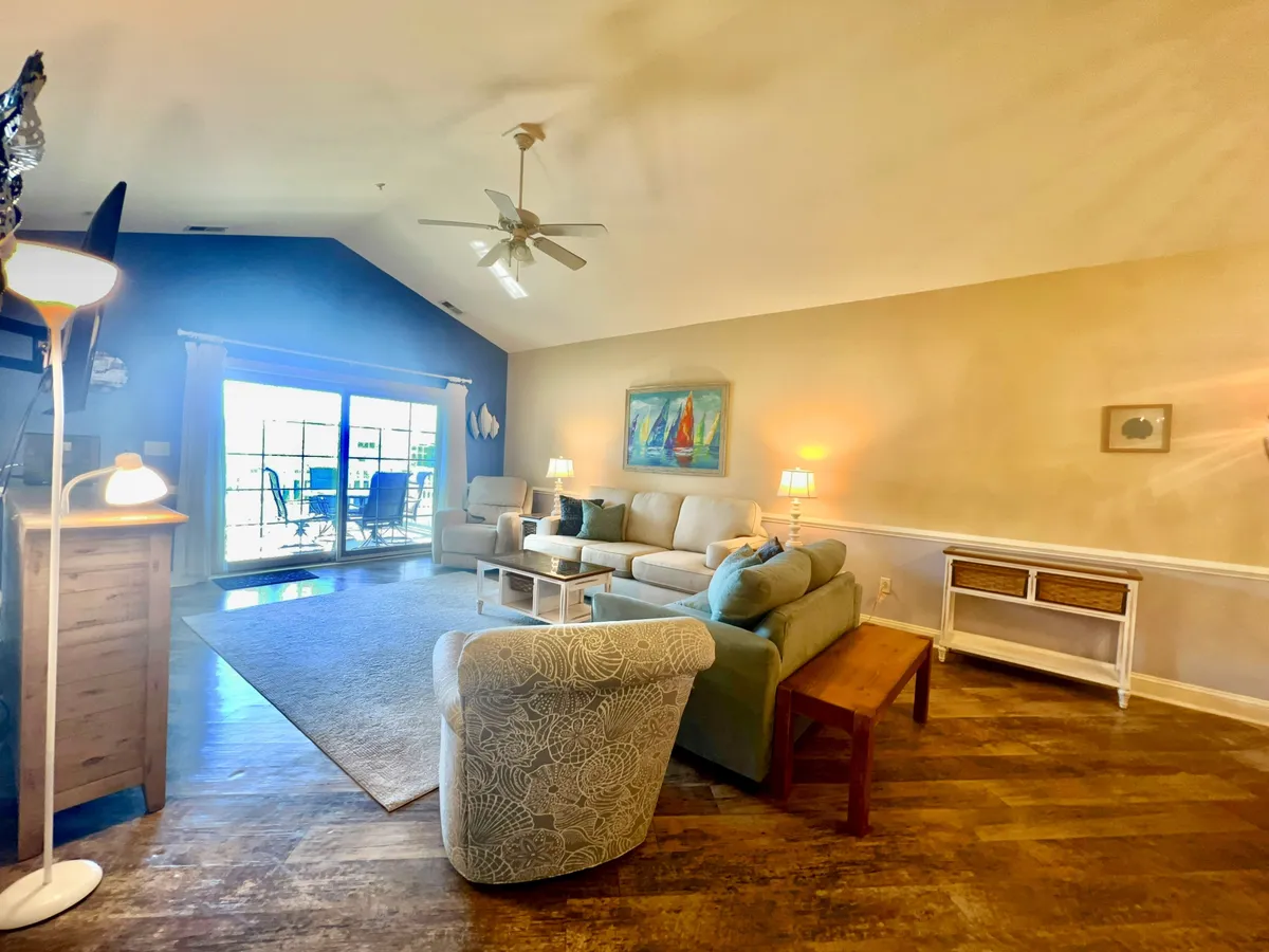 A large window dominates this comfortable seating area, offering expansive views outside. The room is arranged for relaxation, conversation, or simply taking in the scenery, with cozy furnishings and soft lighting that evoke an inviting, restful atmosphere.