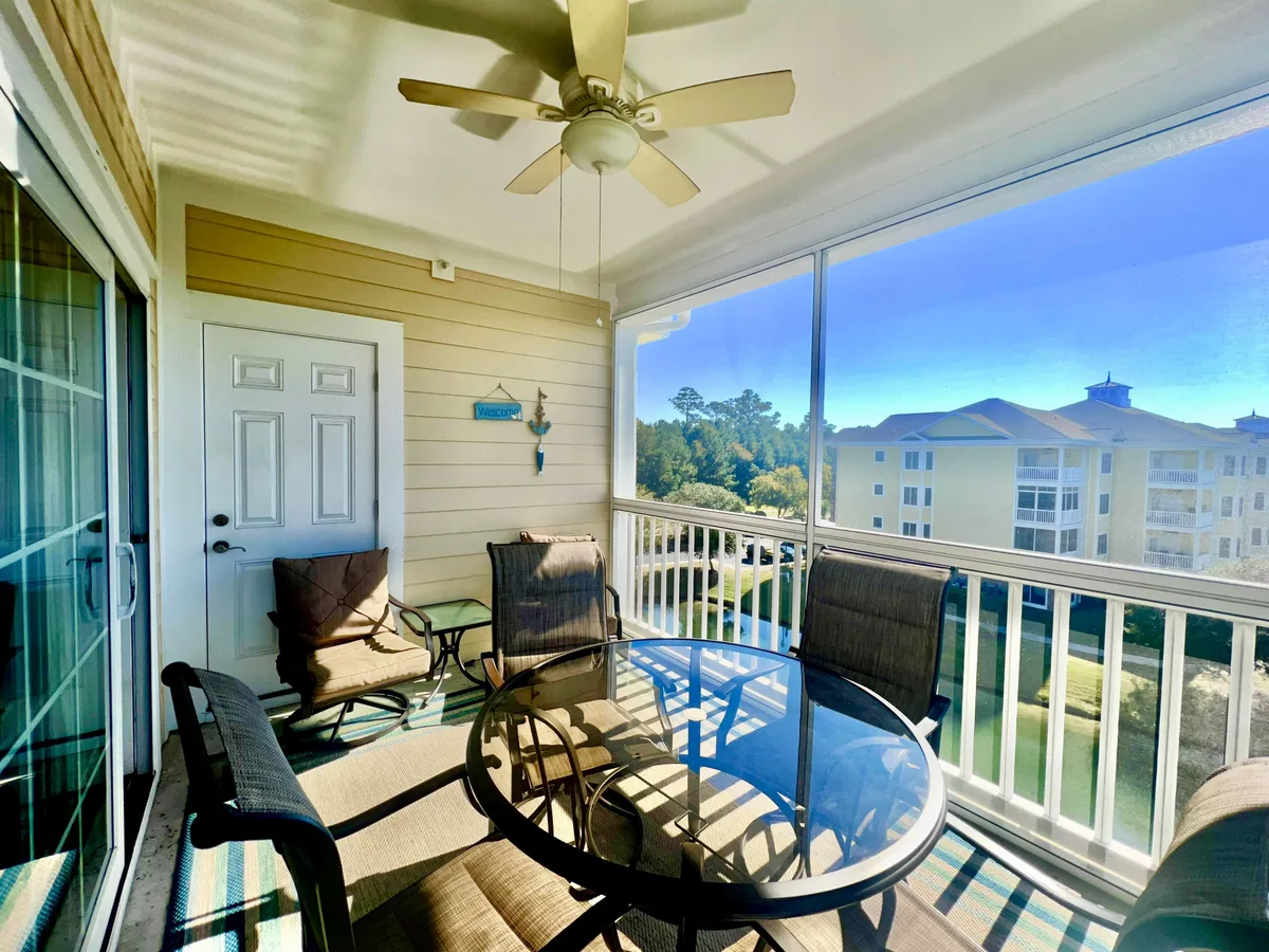 This image offers a view of a glass dining table situated near an open door, revealing an inviting glimpse of the outdoors. The space is bright, airy, and casual, suggesting a seamless connection with the exterior and the possibility to enjoy fresh air, sunsets, or morning light.